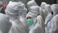 Airline ground staff wearing protective gear work at the counter at the airport in Manila on August 4, 2020. More than 27 million people -- a quarter of the Philippine population -- were give 24-hours notice of the new restrictions that have shuttered man