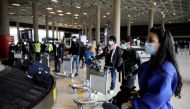 FILE PHOTO: Jordanian students who were studying abroad await their luggage after returning home amid concerns over the spread of the coronavirus, at Queen Alia International Airport in Amman, Jordan, May 6, 2020. REUTERS/Muhammad Hamed/File Photo