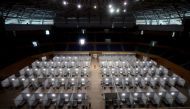 Workers prepare a make-shift field hospital inside the Tien Son sports complex amid the spread of the COVID-19 coronavirus in Danang on August 5, 2020. / AFP / Hoang Khanh