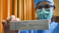 A doctor displays a vaccine for COVID-19 coronavirus at Padjadjaran university educational hospital in Bandung, West Java on July 6, 2020, in preparation for efforts to vaccinate 1,620 volunteers in the community next week. / AFP / TIMUR MATAHARI