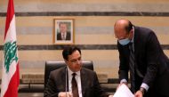 Lebanon's Health Minister Hamad Hasan talks to Lebanon's Prime Minister Hassan Diab during a cabinet meeting at the government palace in Beirut, Lebanon, August 10, 2020. REUTERS/Mohamed Azakir