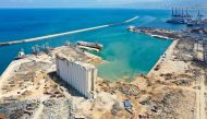 An aerial view taken on August 9, 2020, shows a general view of the port of Beirut, the damaged grain silo and the crater caused by the colossal explosion of a huge pile of ammonium nitrate that had languished for years in a port warehouse, leaving scores