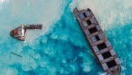 TOPSHOT - An aerial view taken in Mauritius on August 17, 2020, shows the MV Wakashio bulk carrier, belonging to a Japanese company but Panamanian-flagged, that had run aground and broke into two parts near Blue Bay Marine Park. / AFP / -