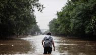 A man walks through a waterlogged street following monsoon rainfalls in Gurgaon on the outskirts of New Delhi on August 19, 2020. 