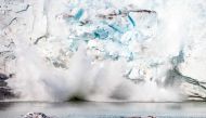 This file photo taken on August 17, 2019 shows an iceberg calving with a mass of ice breaking away from the Apusiajik glacier, near Kulusuk (aslo spelled Qulusuk), a settlement in the Sermersooq municipality located on the island of the same name on the s