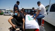 Mourners sit next to the coffin of Reham Yacoub, a female activist who was killed by unidentified gunmen, during her funeral in Basra, Iraq August 20, 2020. REUTERS/Essam al-Sudani/File Photo