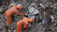 Rescue workers search for survivors in the rubble of a collapsed five-storey apartment building in Mahad on August 25, 2020. / AFP / Punit PARANJPE