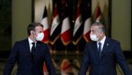 French President Emmanuel Macron (L) and Iraq's Prime Minister Mustafa al-Kadhemi, mask-clad due to the COVID-19 coronavirus pandemic, give a joint press conference in Baghdad on September 2, 2020.  AFP / POOL / GONZALO FUENTES
