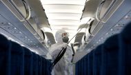 A health worker sprays disinfectant inside a Vietnam Airlines airplane to protect from the recent coronavirus outbreak, at Noi Bai airport in Hanoi, Vietnam February 21, 2020. REUTERS/Kham/File Photo