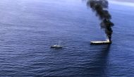 This handout photograph taken on September 3, 2020, and released by Sri Lanka's Air Force, shows black smoke coming out from the Panamanian-registered crude oil tanker, MT New Diamond, some 60 kilometres (38 miles) off Sri Lanka's eastern coast where it r