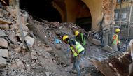 Workers remove the rubble beneath a partially-destroyed traditional Lebanese building in the Gemmayzeh neighbourhood of the capital Beirut, in the aftermath of the devastating port blast, on August 26, 2020. A massive fertiliser explosion at the Beirut po