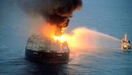TOPSHOT - This handout photograph taken on September 4, 2020, and released by Sri Lanka's Air Force, shows an Indian coast guard ship (R) battling to extinguish the fire from the Panamanian-registered crude oil tanker New Diamond, some 60 km off Sri Lanka