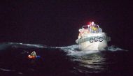TOPSHOT - This handout picture taken on September 2, 2020 and provided by 10th Regional Coast Guard Headquarters on September 3, 2020 shows coast guards rescuing a Filipino man off Amami Oshima island, about 120 km northwest of the sea. Japan's coast guar