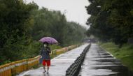 A woman takes a walk as it rains amid the coronavirus disease (COVID-19) pandemic at a Han River park in Seoul, South Korea, September 2, 2020. REUTERS/Kim Hong-Ji/File Photo