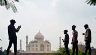 People take pictures with their mobile phones near the Taj Mahal in Agra on September 8, 2020. AFP / Pawan Sharma 