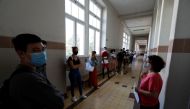 Students wearing protective face masks attend their first day of classes at Maria Amalia Vaz de Carvalho High School, as high school students return to schools under strict restrictions, amid the coronavirus disease (COVID-19) outbreak, in Lisbon, Portuga