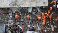 Rescue workers search for survivors in the rubble of a collapsed three-storey residential building in Bhiwandi on September 21, 2020. Ten people were killed and up to 25 were feared trapped after a three-storey residential building collapsed before dawn o