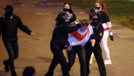 Riot police officers detain a man during an opposition rally to protest against the presidential inauguration in Minsk, on September 23, 2020.  AFP