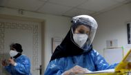 FILE PHOTO: A nurse wearing a protective suit and mask checks the files at Hazrate Ali Asghar Hospital amid the coronavirus disease (COVID-19), in Tehran, Iran September 27, 2020. Majid Asgaripour/WANA  

