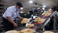 Workers wearing protective masks prepare baked breads inside a bakery in Beirut, Lebanon October 8, 2020. Picture taken October 8, 2020. REUTERS/Mohamed Azakir
