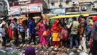 People wearing facemasks as a preventive measure against the Covid-19 coronavirus crowd in a market area in the old quarters of New Delhi on October 11, 2020. AFP / Sajjad Hussain 