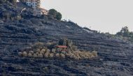 A picture taken on October 11, 2020, shows a church in the middle of a scorched hillside due to forest fires in the countryside of the Syrian western city of Tartus.  AFP / LOUAI BESHARA