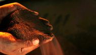 A worker poses with a handful of nickel ore at the nickel mining factory of PT Vale Tbk, near Sorowako, Indonesia, January 8, 2014. REUTERS/Yusuf Ahmad/File Photo/File Photo