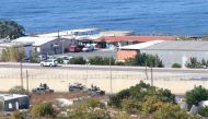 A general view shows UNIFIL and Lebanese military vehicles guarding the area around the UNIFIL base (not seen in picture) where Israeli and Lebanese delegtaions were having their first round of talks in the southern Lebanese border town of Naqura on Octob