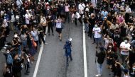 A pro-democracy activist covered in blue paint uses a megaphone during an anti-government protest, in Bangkok, Thailand October 17, 2020. REUTERS/Soe Zeya Tun