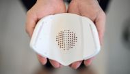This picture taken on September 29, 2020 shows Donut Robotics chief executive Taisuke Ono showing the interior of the smart mask 