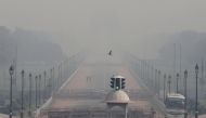 People walk near India Gate on a smoggy morning in New Delhi, India, October 22, 2020. REUTERS/Anushree Fadnavis/File Photo
