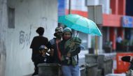 An evacuating family waits for instructions from village officials in the coastal area of Legaspi City, Albay province south of Manila on october 25, 2020, ahead of tropical storm Molave's expected landfall. / AFP / Charism SAYAT