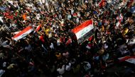 Iraqi demonstrators gather to mark the first anniversary of the anti-government protests in Baghdad, Iraq October 25, 2020. REUTERS/Thaier Al-Sudani