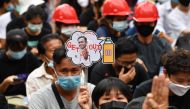A pro-democracy protester holds a sign with the image of Thailand's Prime Minister Prayut Chan-O-Cha urging him leave office at an anti-government rally in Bangkok on October 25, 2020, as activists continued their calls for his resignation. / AFP / Mladen