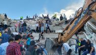 Locals and officials search for survivors at a collapsed building after a strong earthquake struck the Aegean Sea on Friday and was felt in both Greece and Turkey, where some buildings collapsed in the coastal province of Izmir, Turkey, October 30, 2020. 