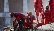 Rescue workers remove rubble during the ongoing search operation at the site of a collapsed building as they look for survivors and victims in the city of Izmir on November 2, 2020, after a powerful earthquake struck Turkey's western coast and parts of Gr