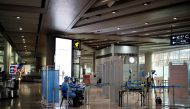 FILE PHOTO: Staff members in protective suits sit at a checkpoint at Beijing Capital International Airport, following new cases of the coronavirus disease (COVID-19) infections, in Beijing, China June 16, 2020. REUTERS/Carlos Garcia Rawlins/File Photo
