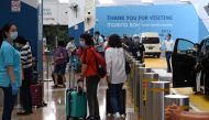 Passengers arrive at the departure area at Marina Bay Cruise Centre in Singapore on November 6, 2020 for 