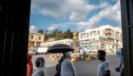 People walk near a square of Emperor Tewodros II in the city of Gondar, Ethiopia, on November 06, 2020. / AFP / EDUARDO SOTERAS
