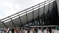 Spectators wearing protective masks amid the coronavirus disease (COVID-19) outbreak enter the venue of Friendship and Solidarity Competition, the first international event at a Tokyo Olympic venue since the Games were postponed in March due to the COVID-