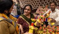 People buy lamps for Diwali, the Hindu festival of lights, on a street in Amritsar on November 14, 2020. / AFP / NARINDER NANU
