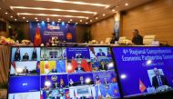 Vietnam's Prime Minister Nguyen Xuan Phuc is pictured on the screen (R) as he addresses his counterparts during the 4th Regional Comprehensive Economic Partnership (RCEP) Summit at the Association of Southeast Asian Nations (ASEAN) summit being held onlin