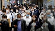 People wearing protective face masks walk on the street, amid the coronavirus disease (COVID-19) outbreak, in Tokyo, Japan November 19, 2020. REUTERS/Issei Kato/File Photo