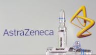 A test tube labeled with the vaccine is seen in front of AstraZeneca logo in this illustration taken, September 9, 2020. REUTERS/Dado Ruvic/File Photo
