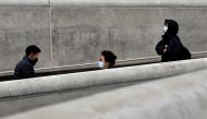 People wearing masks walk along a street amid the coronavirus disease (COVID-19) pandemic in Seoul, South Korea, November 20, 2020. REUTERS/Heo Ran