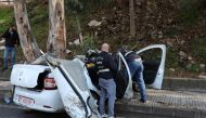 Members of the Lebanese police inspect the damaged car in Hadath, Lebanon, November 21, 2020. REUTERS/Mohamed Azakir