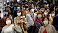 People wearing protective face masks walk on the street, amid the coronavirus disease (COVID-19) outbreak, in Tokyo, Japan November 19, 2020. Reuters/Issei Kato/File Photo
