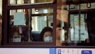 A woman wearing a face mask sits in a bus amid the coronavirus disease (COVID-19) pandemic in Seoul, South Korea, November 27, 2020. REUTERS/Heo Ran