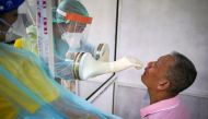 FILE PHOTO: Medical personnel perform a nose swab test on a local resident of a community in Bangkok, amid the coronavirus disease (COVID-19) outbreak in Thailand, April 28, 2020. REUTERS/Athit Perawongmetha
