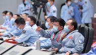 This photo taken on December 1, 2020 shows technical personnel monitoring the process during the Chang'e-5 lunar probe landing on the moon at the Beijing Aerospace Control Center in Beijing. An unmanned Chinese spacecraft landed on the Moon on December 1,